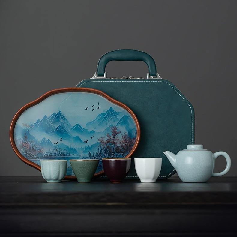 Five Great Kilns-inspired travel tea set with a Xishi teapot, four tasting cups, landscape tray, and teal travel case