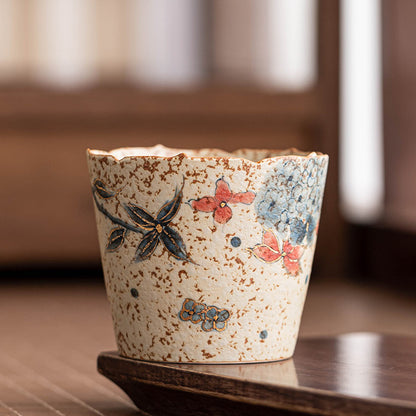 Hand-painted Jingdezhen hydrangea ceramic coffee cup with a flower-shaped rim on a dark wooden stand