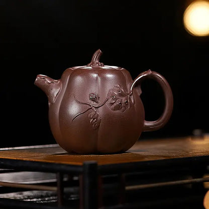 Handcrafted deep reddish-brown pumpkin-shaped zisha teapot with raised vine and leaf relief