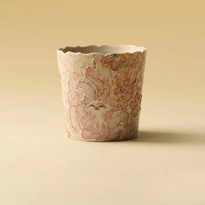 Hand-painted nine-tailed fox petal-rim ceramic coffee cup on a warm beige background
