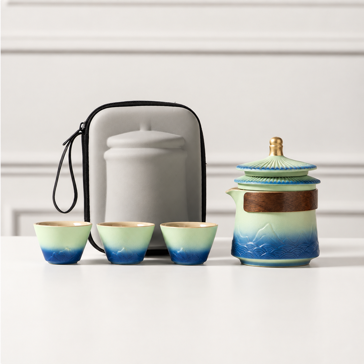 Palace-eaves travel tea set with teapot, three cups and gray carry bag
