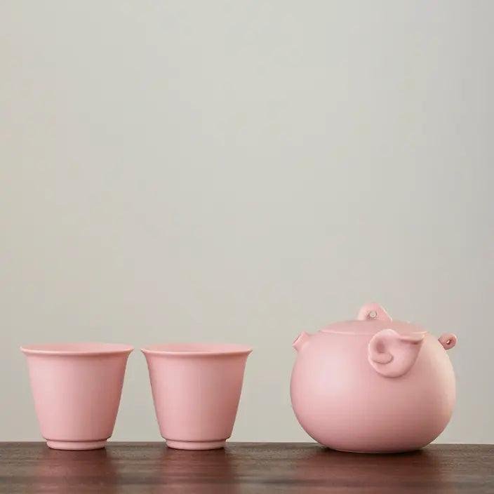 Pink zisha pig teapot with two matching tasting cups
