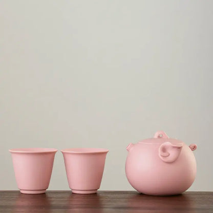 Pink zisha pig teapot with two matching tasting cups
