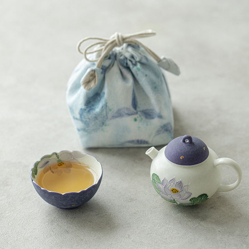 Hand-painted purple lotus ceramic travel tea set for one with teapot, flower-rim cup, and drawstring pouch