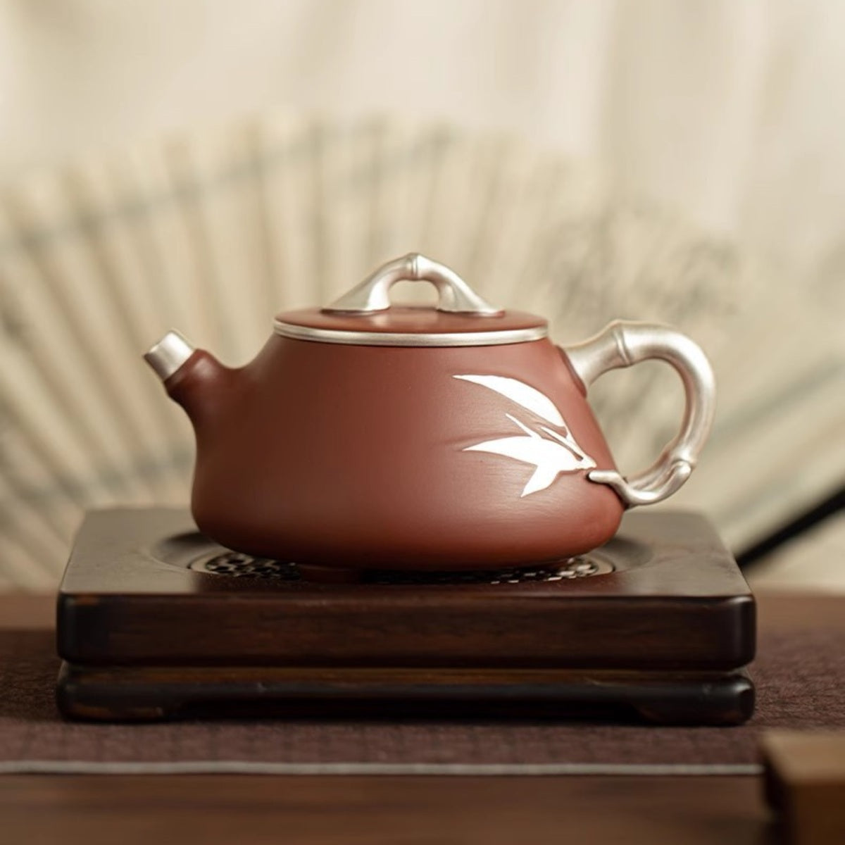 Yixing Dahongpao zisha teapot with silver-tone bamboo handle and leaf detail