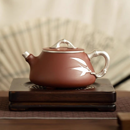 Yixing Dahongpao zisha teapot with silver-tone bamboo handle and leaf detail