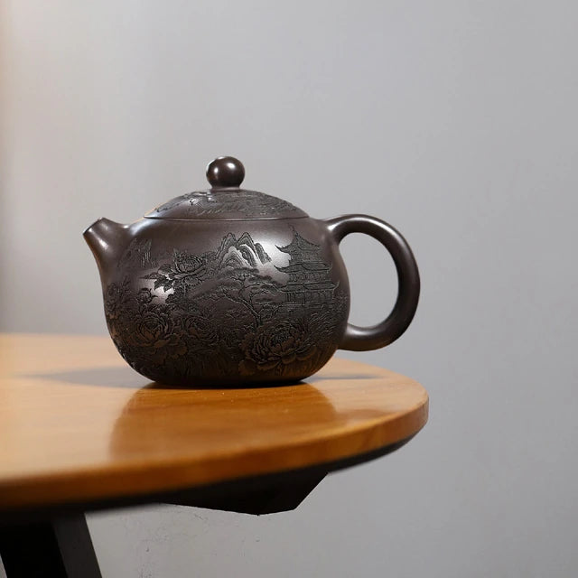 Large-capacity dark brown Yixing zisha Xishi teapot with carved peony, mountain, and pavilion motifs