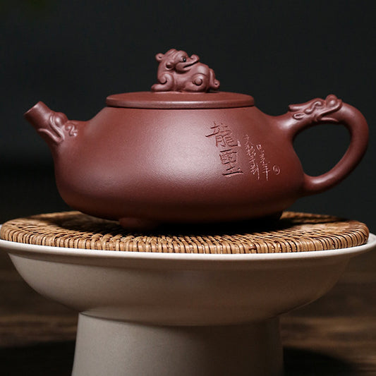 Carved inscription side of the Yixing zini clay dragon teapot on a woven stand