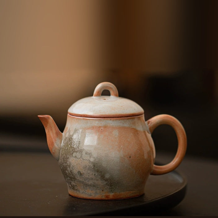 Liqin handmade ceramic teapot with orange, cream, and gray kiln-glazed finish