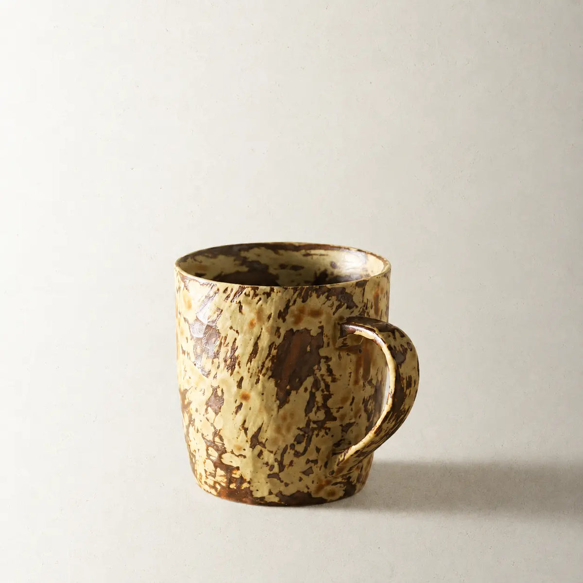 Mango Yellow handmade reactive glaze ceramic coffee mug on a warm neutral background
