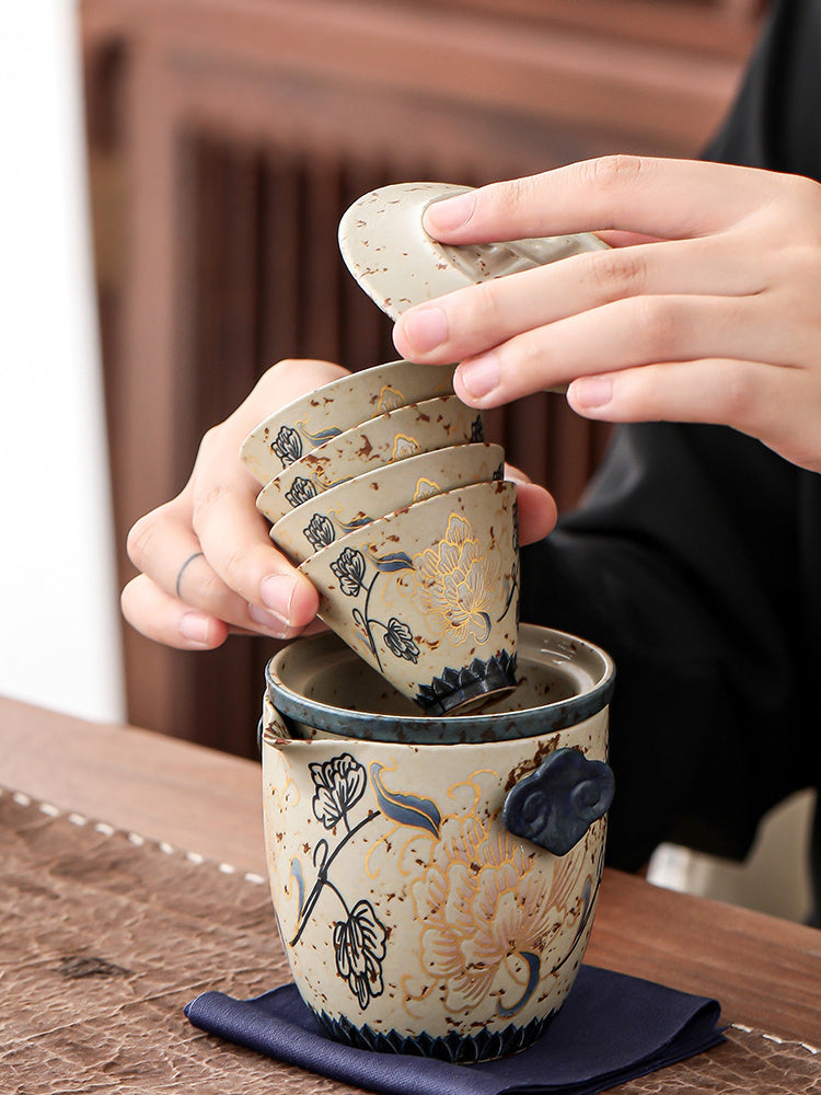 Four peony teacups nesting inside the filtered ceramic travel teapot
