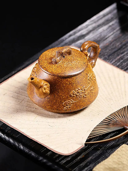 Angled view of the plum blossom Shi Piao zisha teapot on a tea table