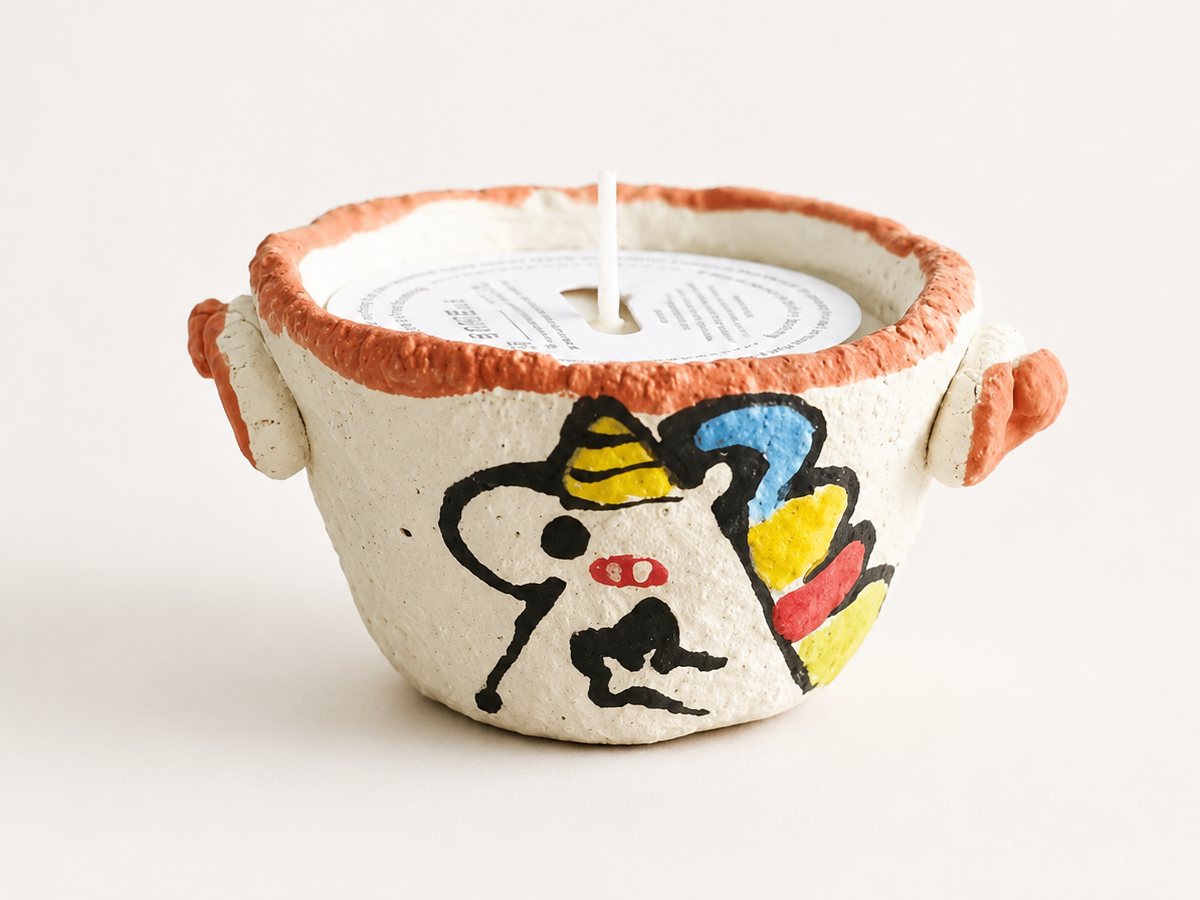 Hand-painted Unicorn ceramic scented candle with textured white glaze and orange rim