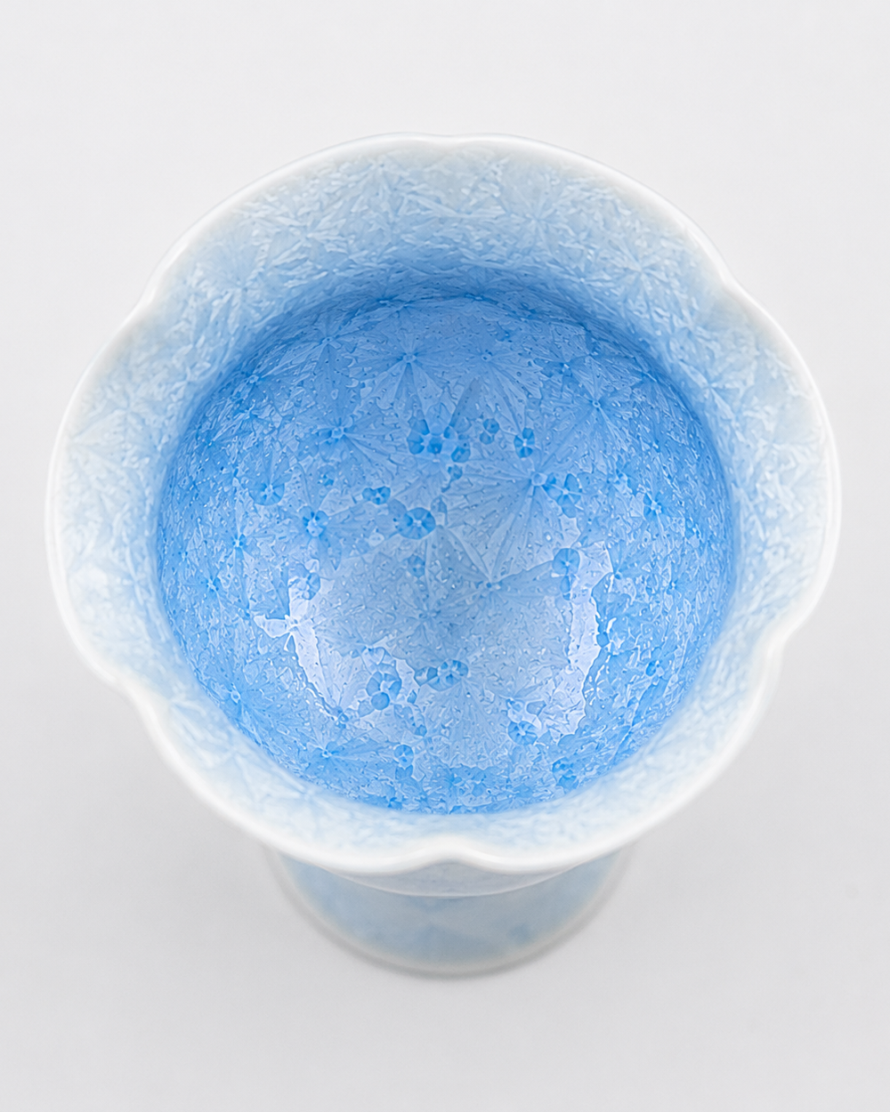 Top view of a pale blue crystalline glaze tea cup showing crystal patterns inside