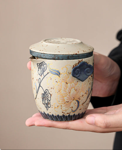 Hand holding the compact peony ceramic travel teapot
