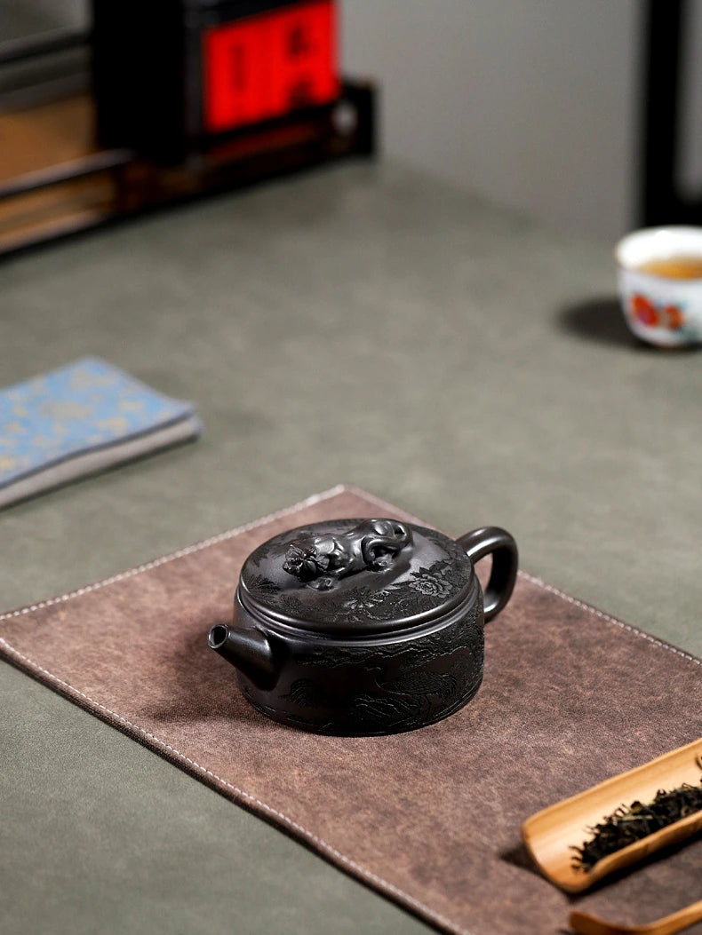 Angled top view of the Crouching Tiger Hidden Dragon teapot resting on a brown tea mat