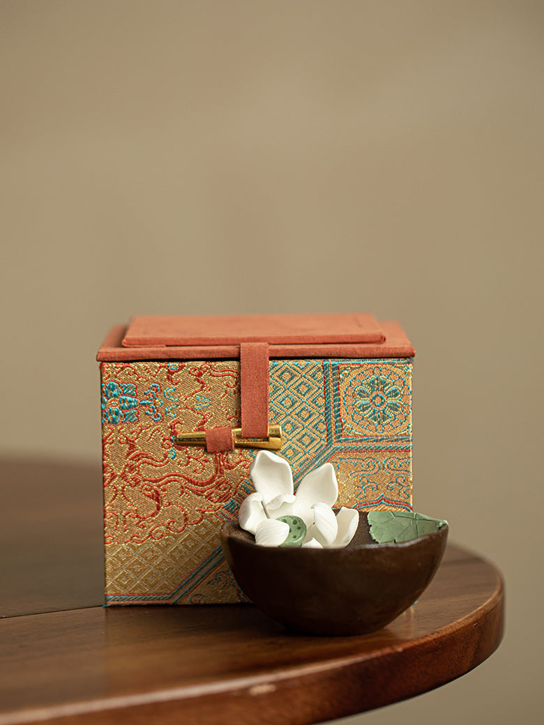 Wood-fired lotus tea cup displayed in front of its patterned gift box