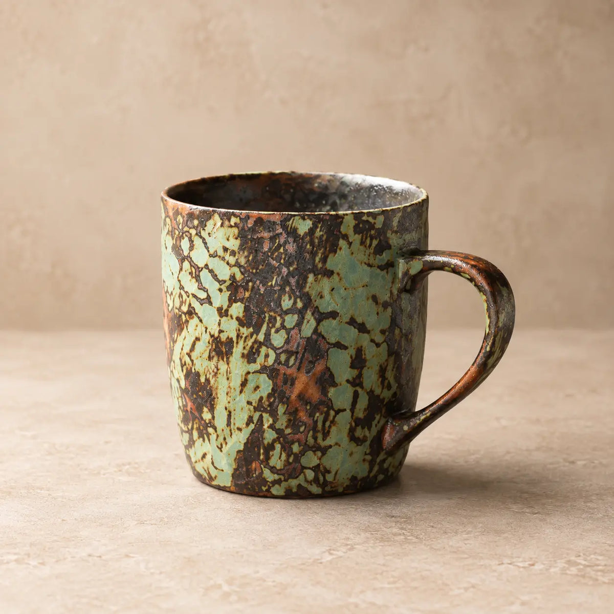 Mint Green handmade reactive glaze ceramic coffee mug on a warm neutral background
