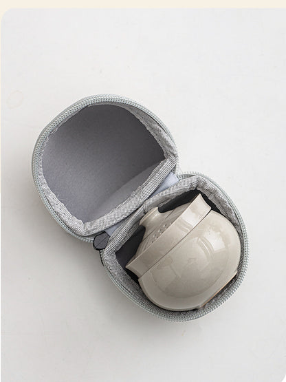 Compact gray ceramic tea set nested securely inside the open zippered travel case
