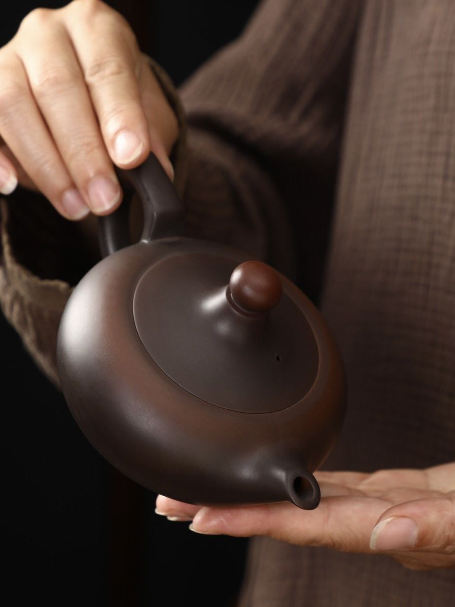 Top view of a handmade Fengming teapot showing the lid, handle, and spout