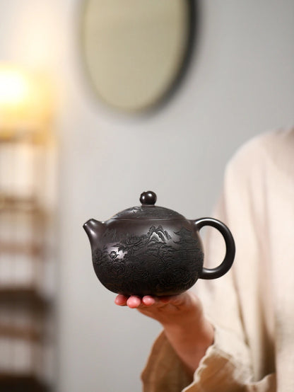 Hand holding the large dark brown Yixing zisha teapot to show its rounded Xishi form and scale