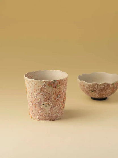 Nine-tailed fox and floral decoration on a petal-rim ceramic cup with a shallow cup behind
