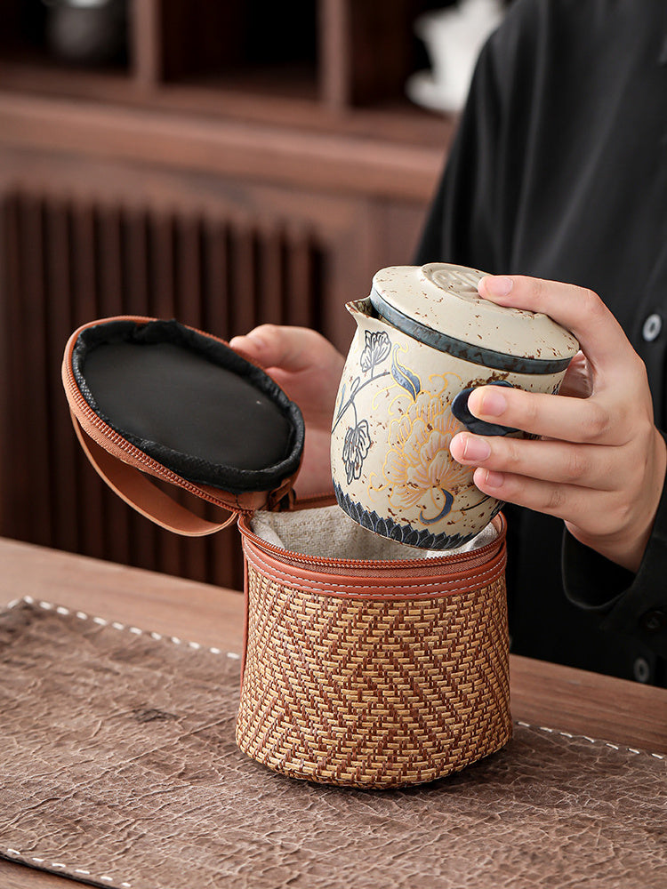 Peony ceramic teapot being placed inside its handled travel case
