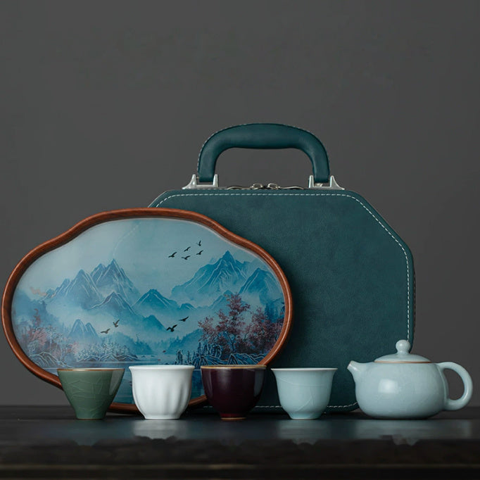 Xishi ceramic teapot with four kiln-inspired tasting cups, a landscape tea tray, and fitted travel case
