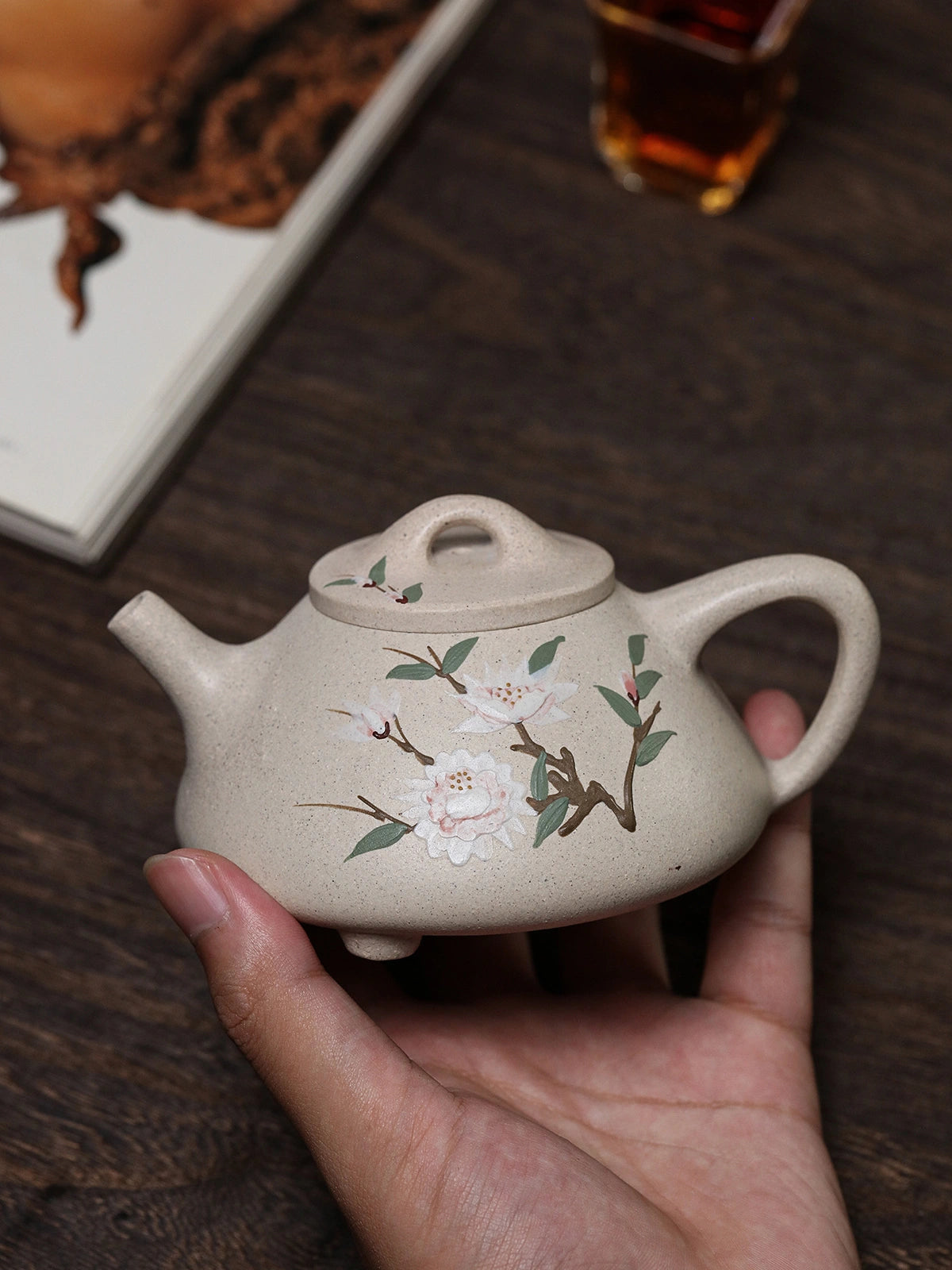 Handheld floral side of the white duanni teapot with branch and blossom slip painting
