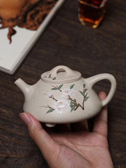 Handheld floral side of the white duanni teapot with branch and blossom slip painting