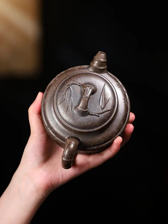 Top view of a bamboo drum zisha teapot with a bamboo-joint lid knob and leaf relief