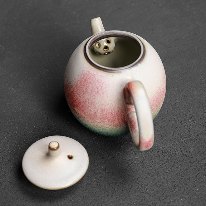 Open Longdan ceramic teapot showing the built-in multi-hole filter and detached lid