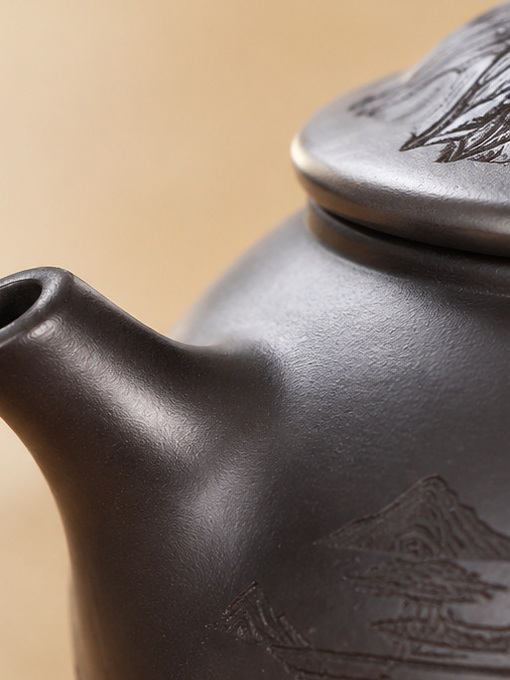 Close-up of the short spout and dark brown surface of the Fengming zisha teapot
