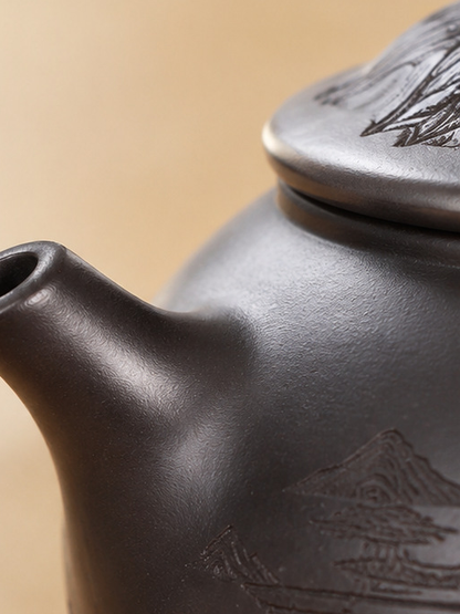 Close-up of the short spout and dark brown surface of the Fengming zisha teapot
