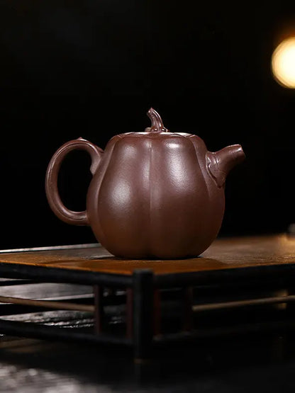 Rear view of a pumpkin-shaped zisha teapot showing its rounded segmented body