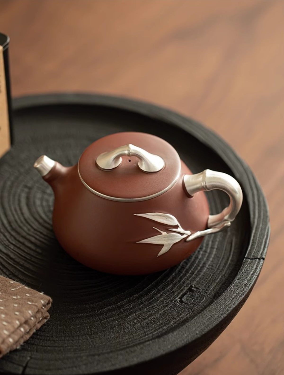 Top view of a handmade Yixing zisha teapot with bamboo-shaped silver-tone details