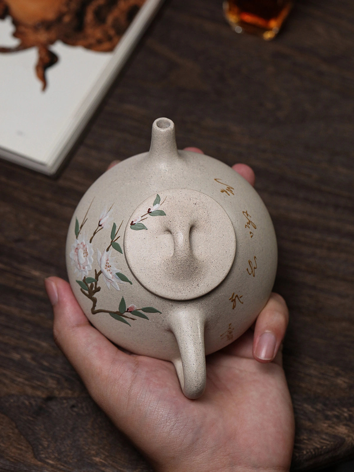 Top view of the Shi Piao teapot showing the lid knob, spout, handle, floral painting, and calligraphy