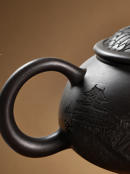 Close-up of the circular handle and pavilion carving on the Fengming zisha teapot
