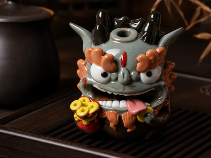 Fortune ceramic Pixiu incense holder displayed on a dark wooden tea table