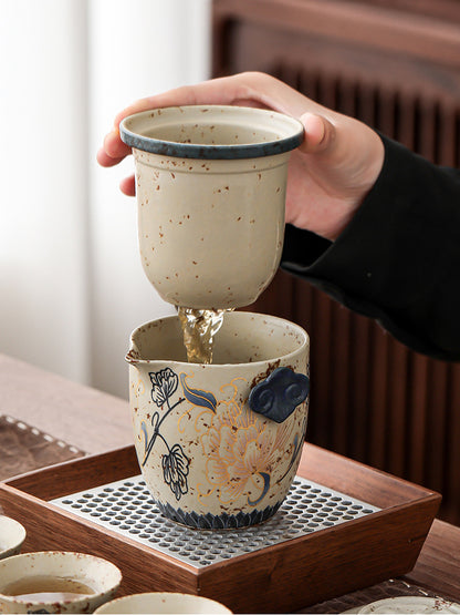 Removable ceramic filter lifted from the peony teapot to separate the tea leaves

