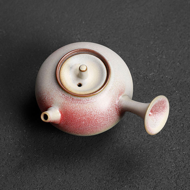 Overhead view of a side-handle rainbow glaze ceramic teapot