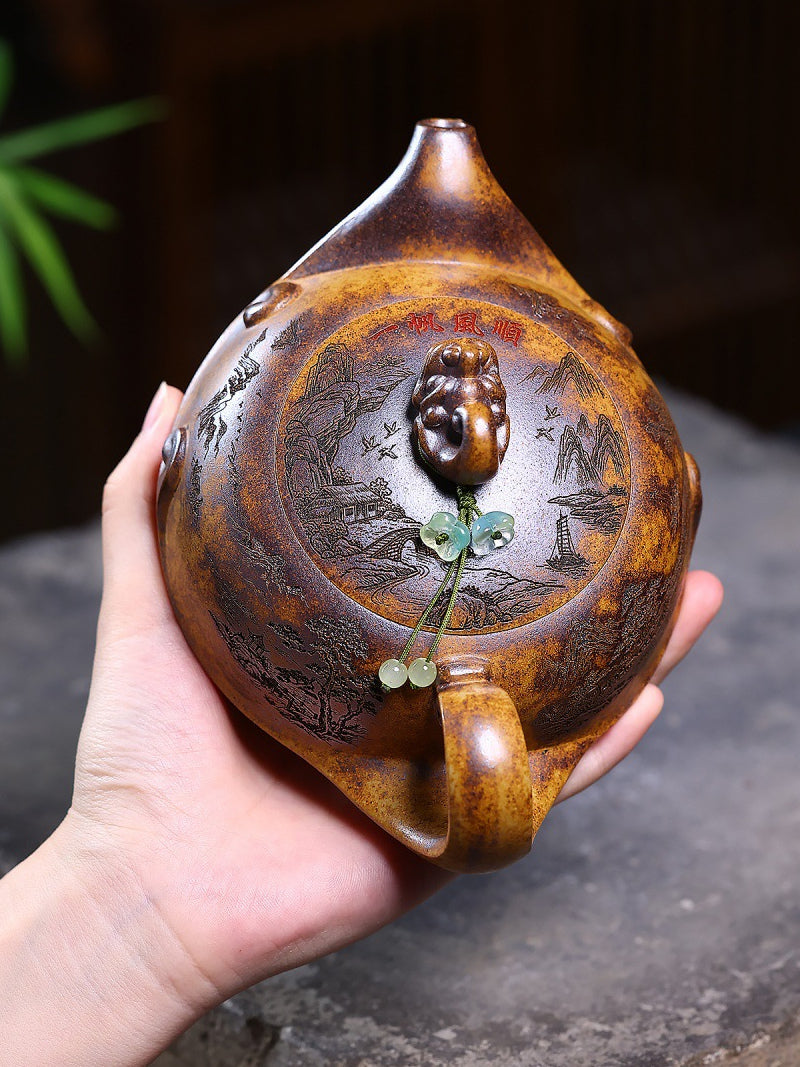 Overhead view of the Yixing zisha teapot showing the carved lid, spout, handle, dragon knob, and green bead
