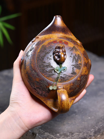 Overhead view of the Yixing zisha teapot showing the carved lid, spout, handle, dragon knob, and green bead

