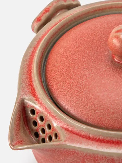 Close-up of the V-shaped teapot spout with built-in filter holes
