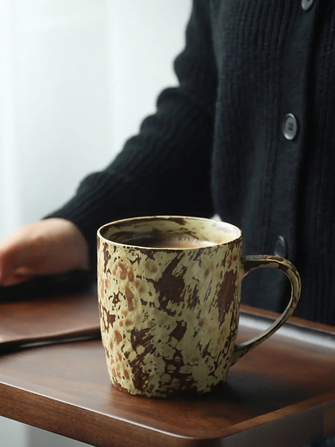 Mango Yellow reactive glaze ceramic mug displayed on a wooden serving tray
