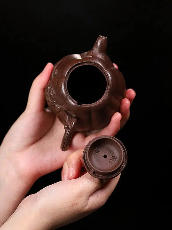 Open pumpkin-shaped zisha teapot and lid showing the clay interior