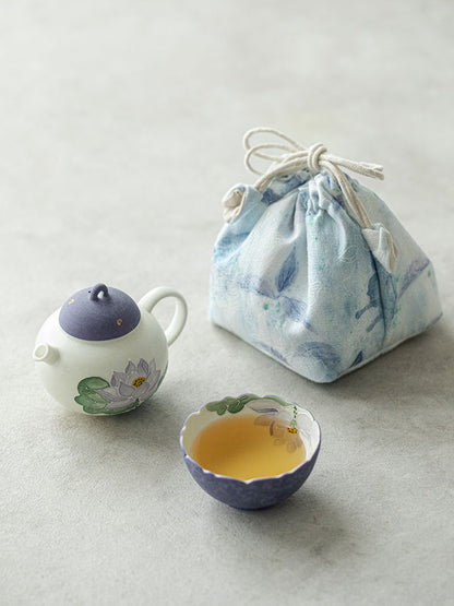 Purple lotus ceramic teapot and flower-rim teacup arranged with the drawstring travel pouch