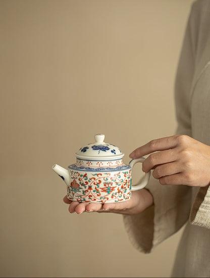 Person holding the handmade lotus ceramic teapot with both hands