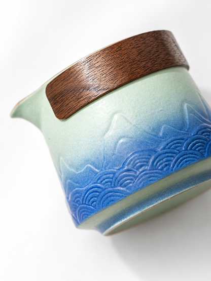 Solid wood grip and mountain-wave relief on the ceramic teapot
