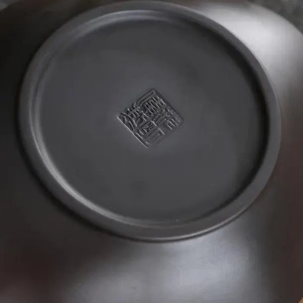 Close-up of the finely finished zisha teapot base with an impressed maker's stamp